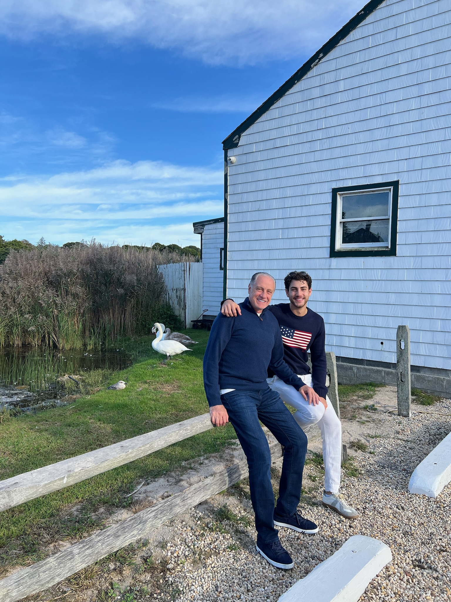 Rene and his dad sitting together by the water