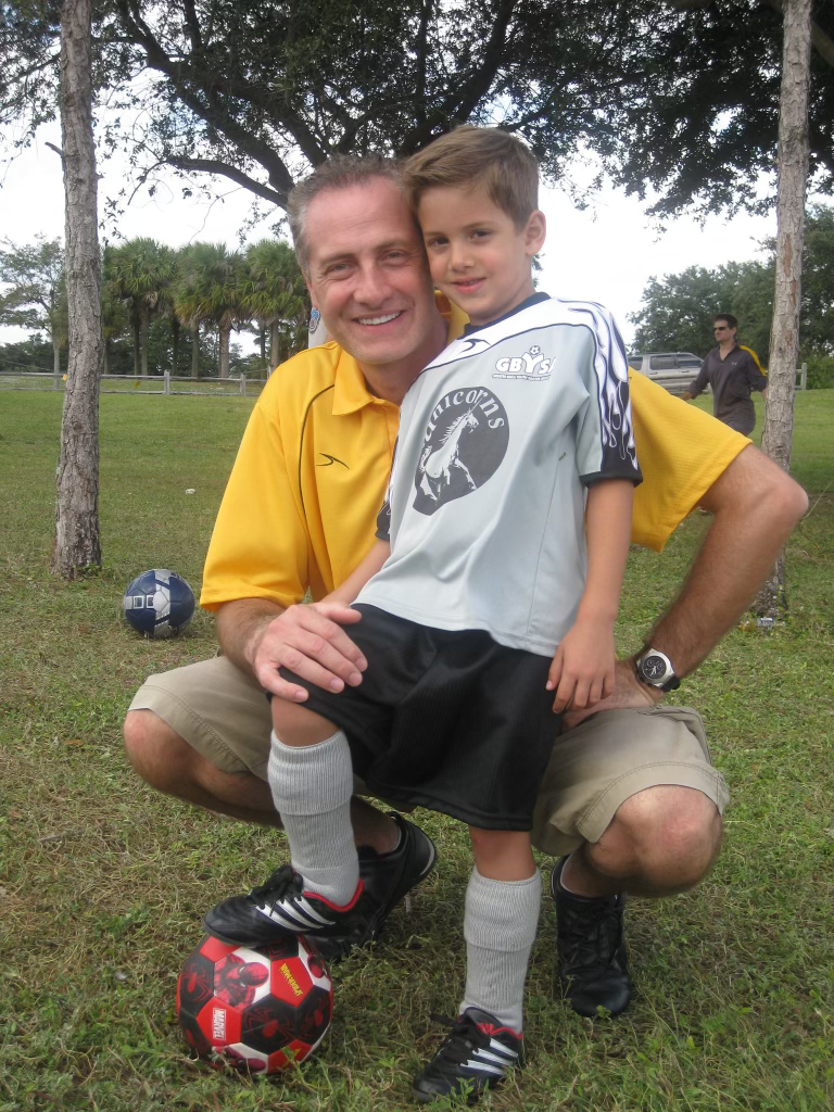Rene with his dad on the soccer field